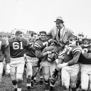 Coach being carried off the field